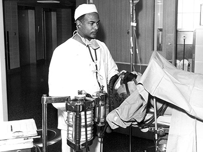 Herman Barnett During Medical Training Herman Barnett, the first African-American student to enroll at UTMB, provides care to a patient during his medical training.